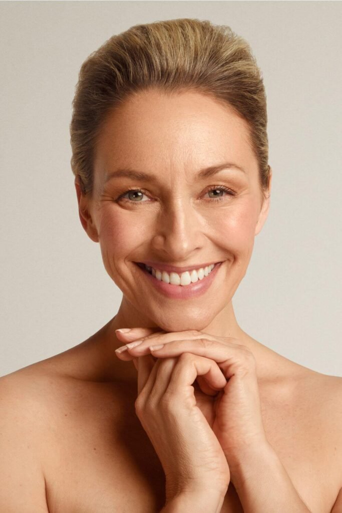 Beautiful CACI model smiling holding hands under chin