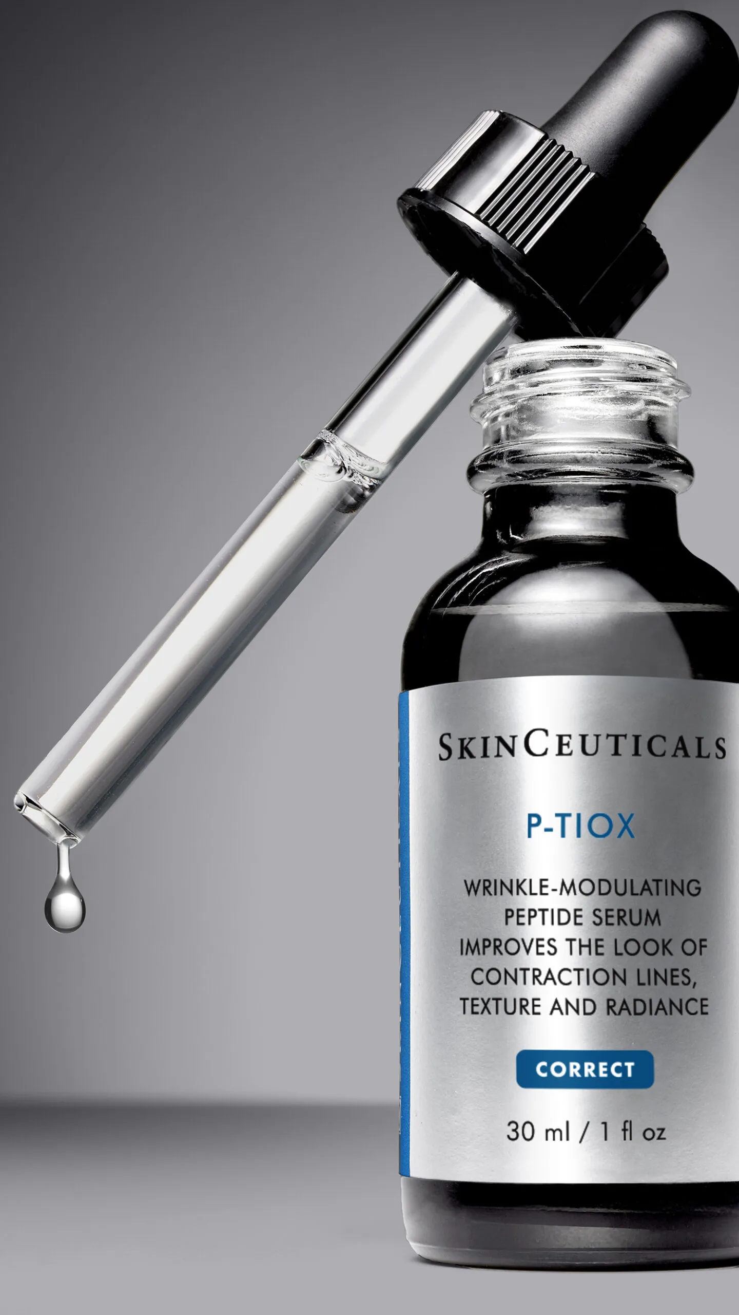 Open bottle of SkinCeuticals P-Tiox Serum with dropper resting on top